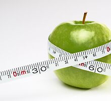 Tape measure round green apple by Sami Sarkis