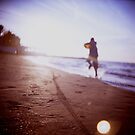 Boy running on beach square Lubitel lomo lomographic lomography medium format  color film analogue photo by edwardolive