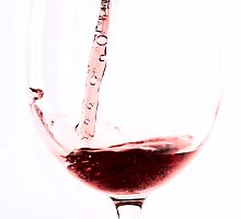 Red wine into wine glass by Arve Bettum