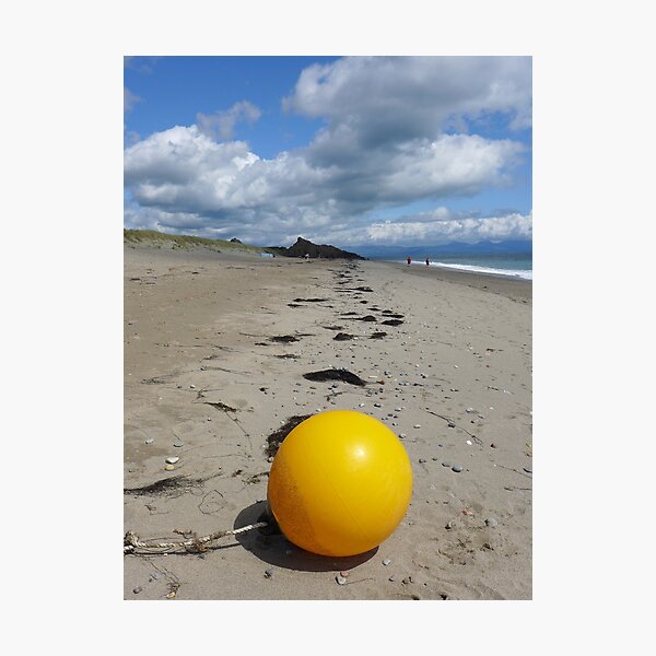 Yellow buoy on the tide line at Pwllheli Photographic Print