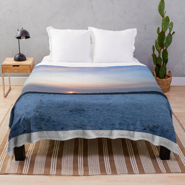 Item preview, Sunrise brightly lit red circle of the rising sun in the winter blue sky over the forest swamp designed and sold by yarvin13.
