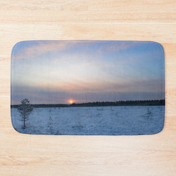 Item preview, Sunrise  brightly lit red circle of the rising sun in the winter blue  sky over the forest swamp designed and sold by yarvin13.