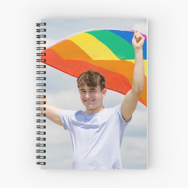 Item preview, A young man holding a Pride flag designed and sold by Ben Gingell.