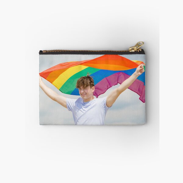 Item preview, A young man holding a Pride flag designed and sold by Ben Gingell.