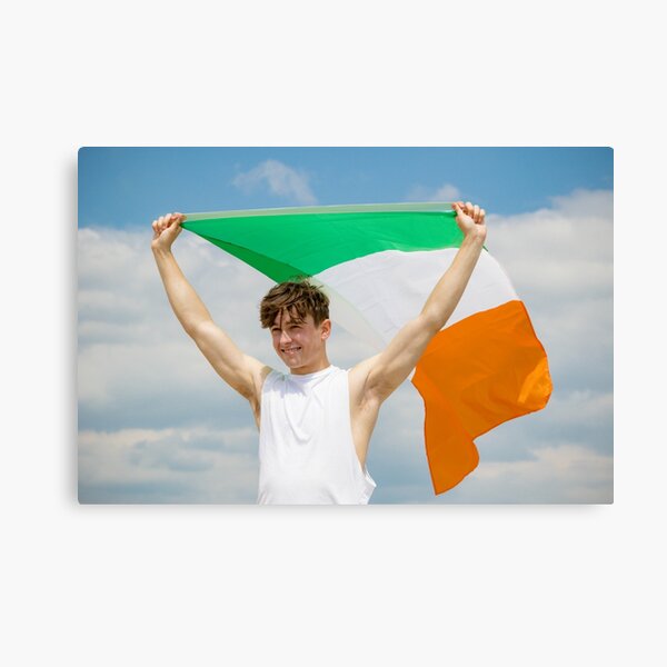 A young man holding the Irish Flag Canvas Print