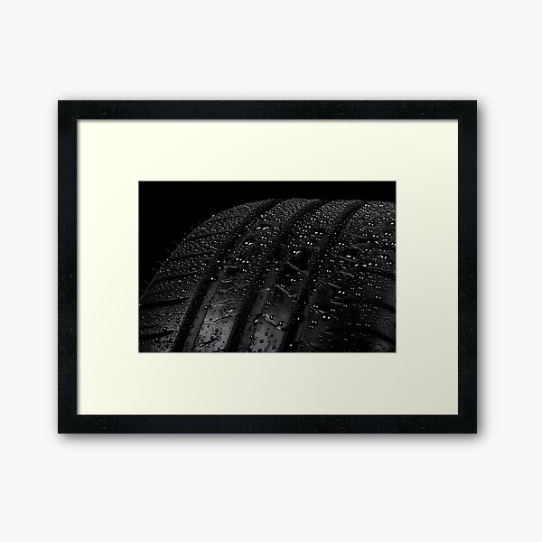 Car tyre isolated on a black background Framed Art Print