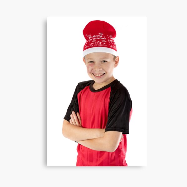 Pre-teen boy wearing a christmas hat Canvas Print