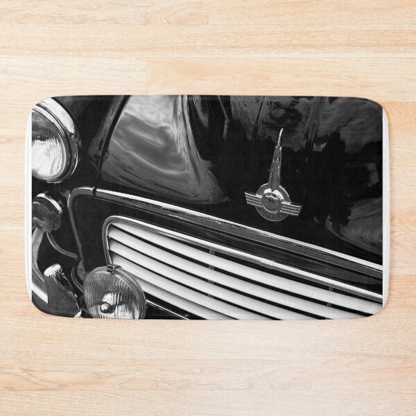 Item preview, A black and white image of the front of a black 1967 Morris Minor Traveller on display at a car show designed and sold by Graham Cornall.