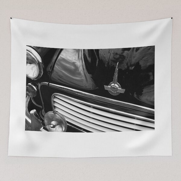 Item preview, A black and white image of the front of a black 1967 Morris Minor Traveller on display at a car show designed and sold by Graham Cornall.