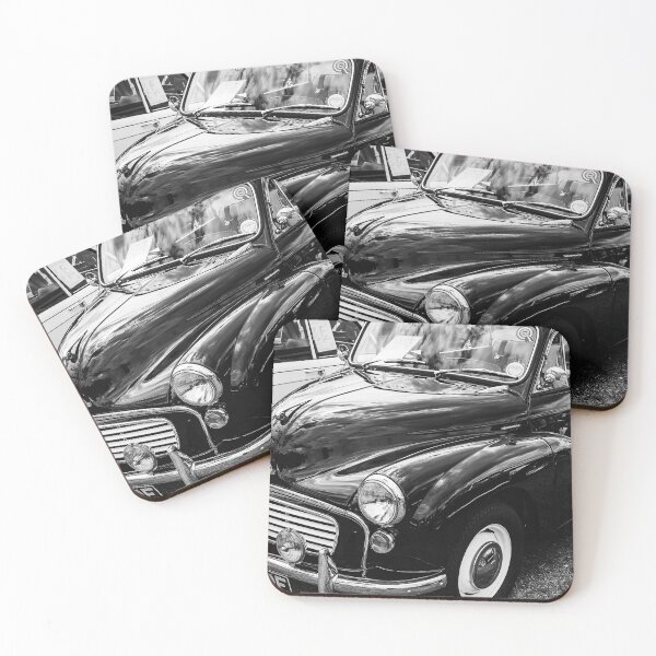 Item preview, A black and white image of the front of a black 1967 Morris Minor Traveller on display at a car show designed and sold by Graham Cornall.