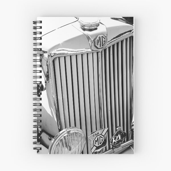 Item preview, A black and white image of the front of a cream 1952 MG TD roadster on display at a car show designed and sold by Graham Cornall.