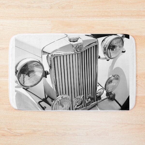 Item preview, A black and white image of the front of a cream 1952 MG TD roadster on display at a car show designed and sold by Graham Cornall.