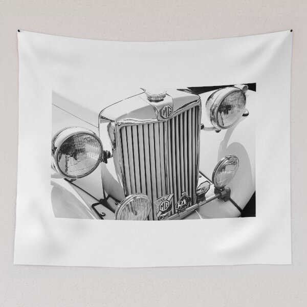 Item preview, A black and white image of the front of a cream 1952 MG TD roadster on display at a car show designed and sold by Graham Cornall.