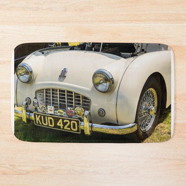 Item preview, The front of a white 1950s Triumph TR3 on display at a car show designed and sold by Graham Cornall.
