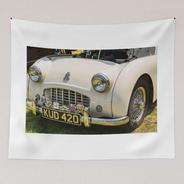 Item preview, The front of a white 1950s Triumph TR3 on display at a car show designed and sold by Graham Cornall.