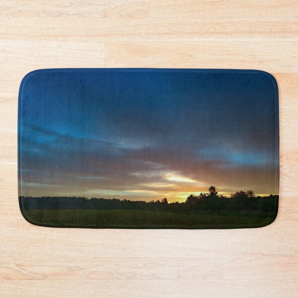 Item preview, Brightly lit colors of the sky at sunrise over a field green grass designed and sold by yarvin13.