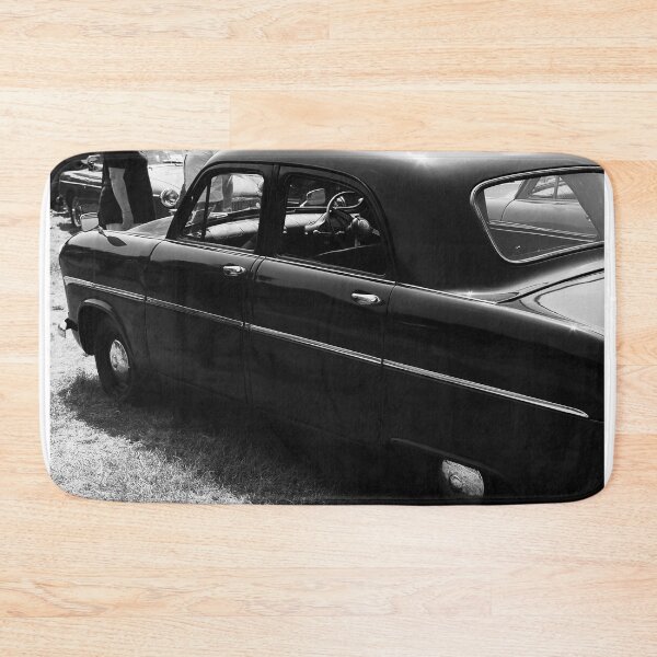 Item preview, A black and white image of the side of a black 1955 Ford Consul on display at a car show designed and sold by Graham Cornall.