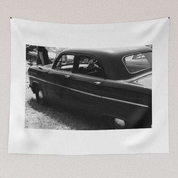 Item preview, A black and white image of the side of a black 1955 Ford Consul on display at a car show designed and sold by Graham Cornall.