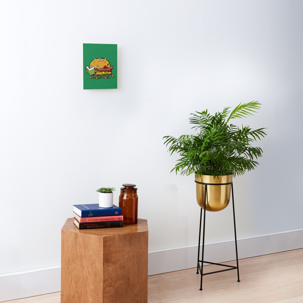 burger with legs reading a book Mounted Print