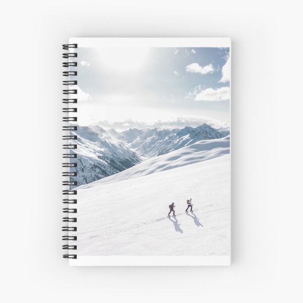 2 hikers in the snow on a mountain. Spiral Notebook