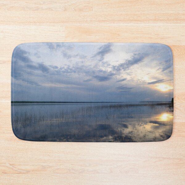Item preview, Sunlight in the cloudy blue sky is reflected in the clear spring water of the lake at sunset designed and sold by yarvin13.