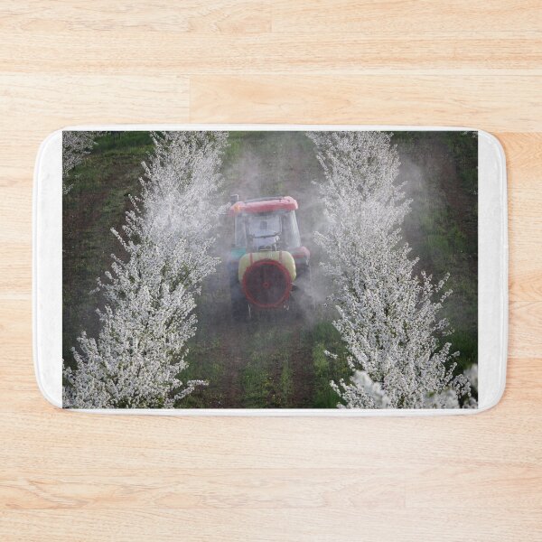 Item preview, tractor sprays insecticide in cherry orchard in spring   designed and sold by goceris.
