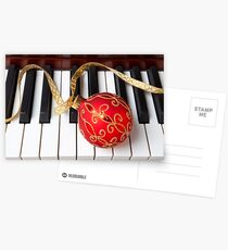Christmas ornament on piano keys Postcards