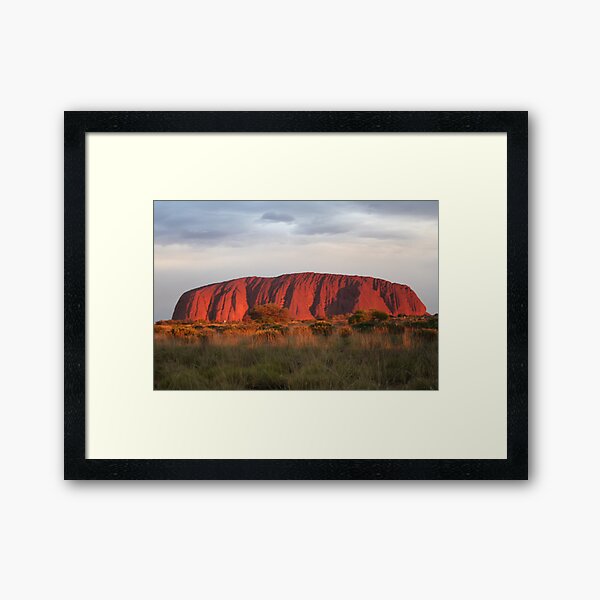 Setting sun shines on Uluru Framed Art Print