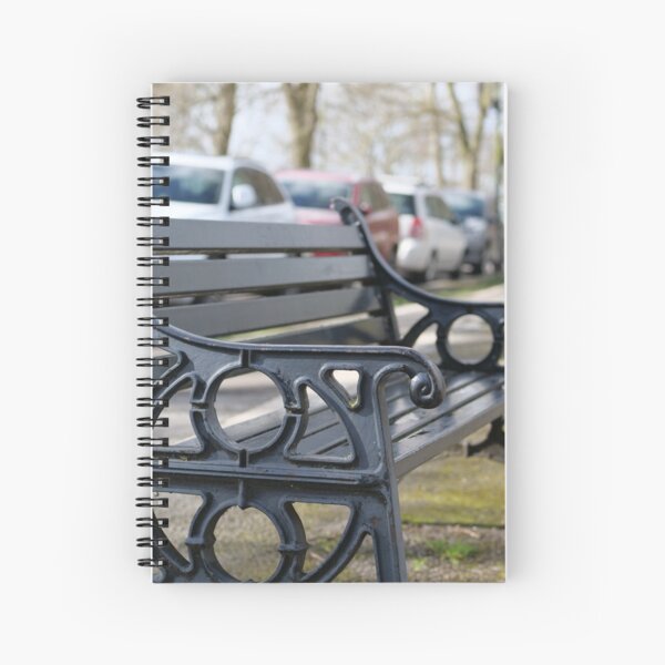 Bench for people to sit along the Thames river embankment in Windsor, Berkshire, England, UK Spiral Notebook