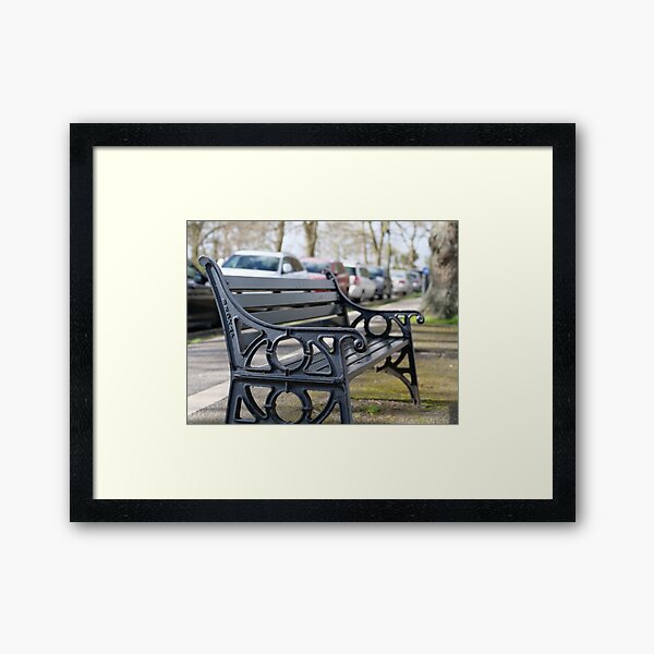 Bench for people to sit along the Thames river embankment in Windsor, Berkshire, England, UK Framed Art Print