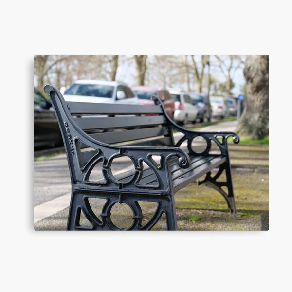 Bench for people to sit along the Thames river embankment in Windsor, Berkshire, England, UK Canvas Print