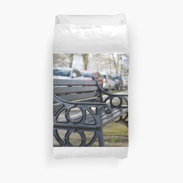 Bench for people to sit along the Thames river embankment in Windsor, Berkshire, England, UK Duvet Cover