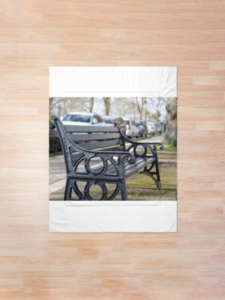 Alternate view of Bench for people to sit along the Thames river embankment in Windsor, Berkshire, England, UK Comforter