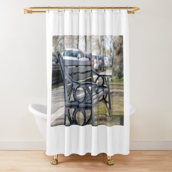 Bench for people to sit along the Thames river embankment in Windsor, Berkshire, England, UK Shower Curtain