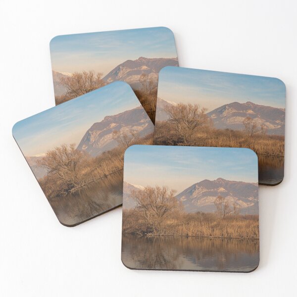 Item preview, Tree in the foreground and mountains in the background are reflected in the river water designed and sold by brambillasimone.