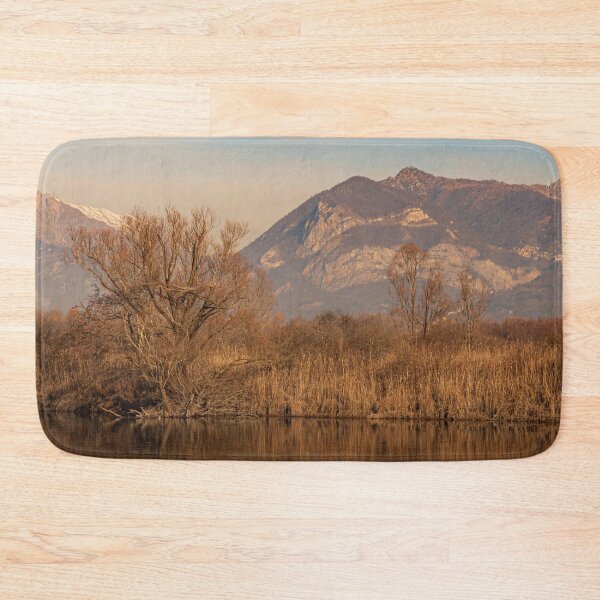 Item preview, Tree in the foreground and mountains in the background are reflected in the river water designed and sold by brambillasimone.