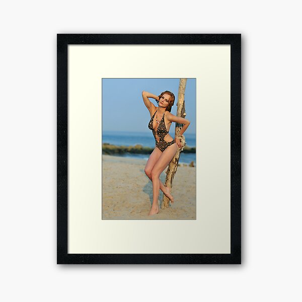 Young redhead girl on the beach standing pretty in designers swimsuit Framed Art Print