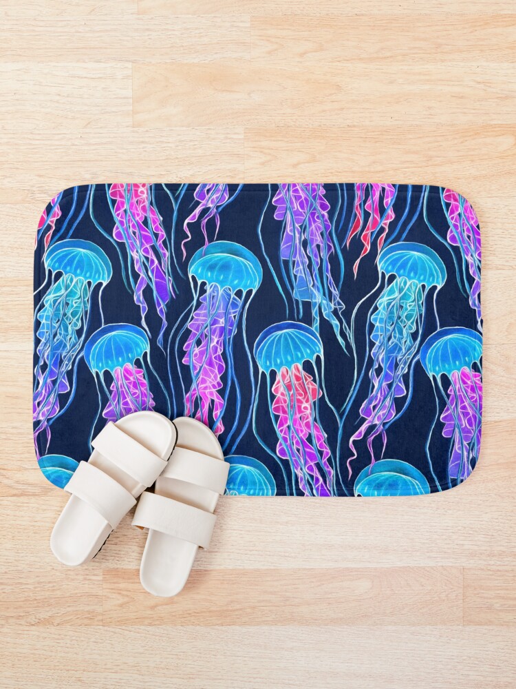 "Luminescent Rainbow Jellyfish on Navy Blue" Bath Mat for Sale by