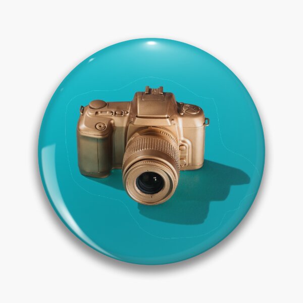 Golden SLR Camera on Cyan Pin