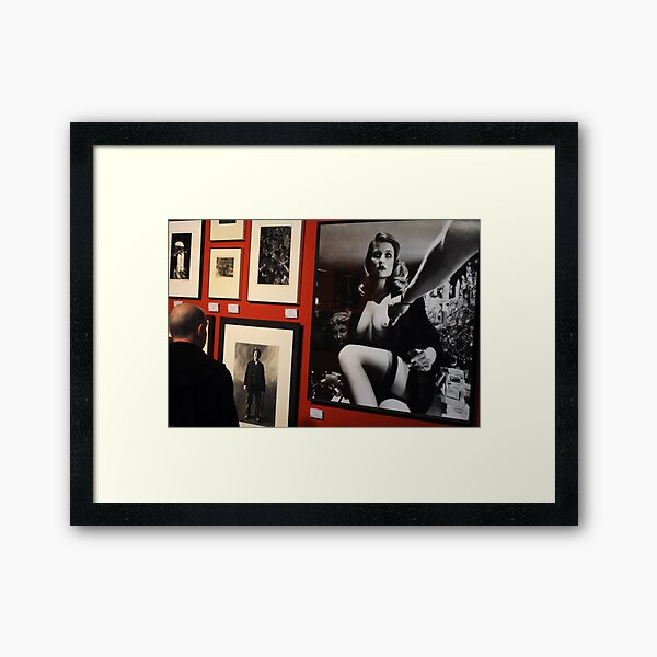 Unknown man looking at Art work of Helmut Newton worth $125.000 Framed Art Print
