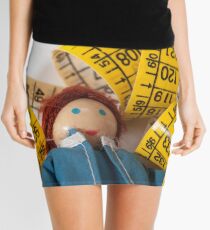 Doll resting on measuring tape Mini Skirt