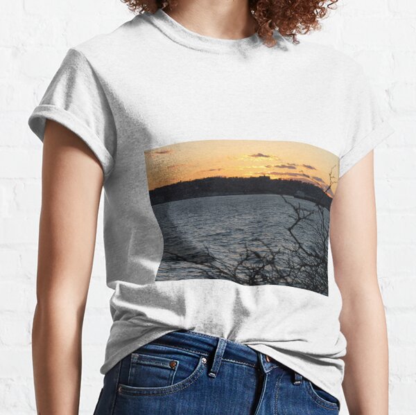 Sunset, also known as sundown, is the daily disappearance of the Sun below the horizon due to Earth's rotation Classic T-Shirt