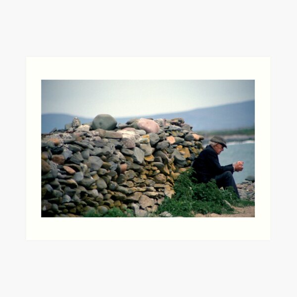 Donegal man contemplating by dry-stone wall close to beach Art Print