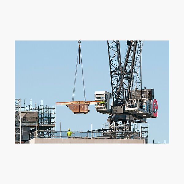 Working Construction Crane loading supplies on Multistory Units. January 29, 2020. Part of a series. Photographic Print