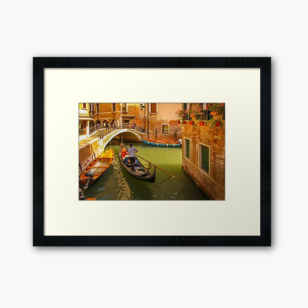 A Gondola Sailing along in the Narrow Canal of Venice, Italy Framed Art Print