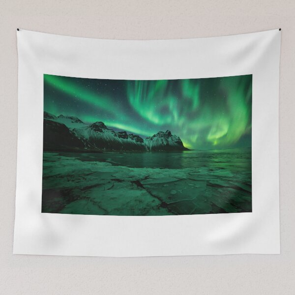 Item preview, Northern lights Iceland above Vestrahorn mountain in Stokksnes with ice in the foreground designed and sold by michieldros.