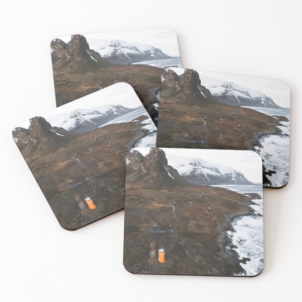 Item preview, Orange lighthouse with cliffs, rocks and mountains in the background at Eystrahorn, Iceland designed and sold by michieldros.