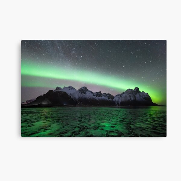 Northern lights and milky way above Vestrahorn mountain in Stokksnes, Iceland with ice in the foreground Canvas Print