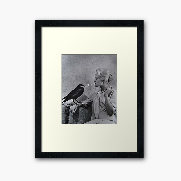 Tippi Hedren having her cigarette lit by a crow on the set of The Birds Framed Art Print