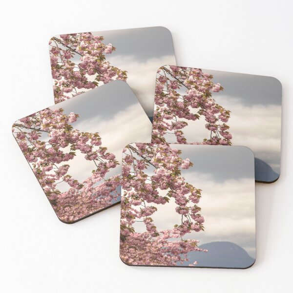 Item preview, Branches of cherry blossoms highlighted against cloudy sky and mountain background designed and sold by Rod Raglin.